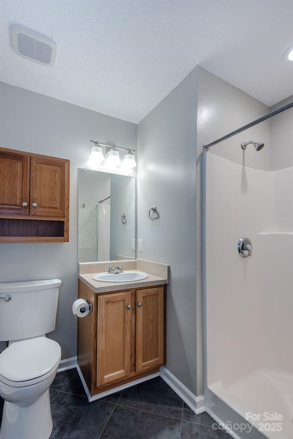 263 Newberry Drive Fletcher, NC 28732 - Photo 7 of 29 a bathroom with a granite countertop sink toilet and shower