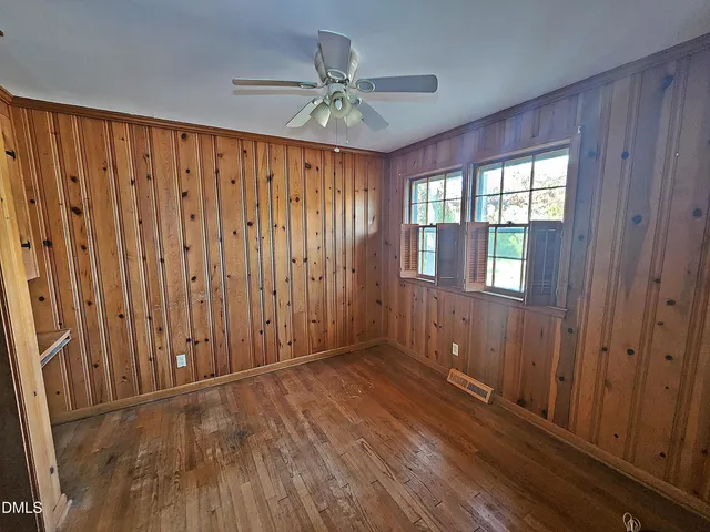 a view of a livingroom with a ceiling fan and window