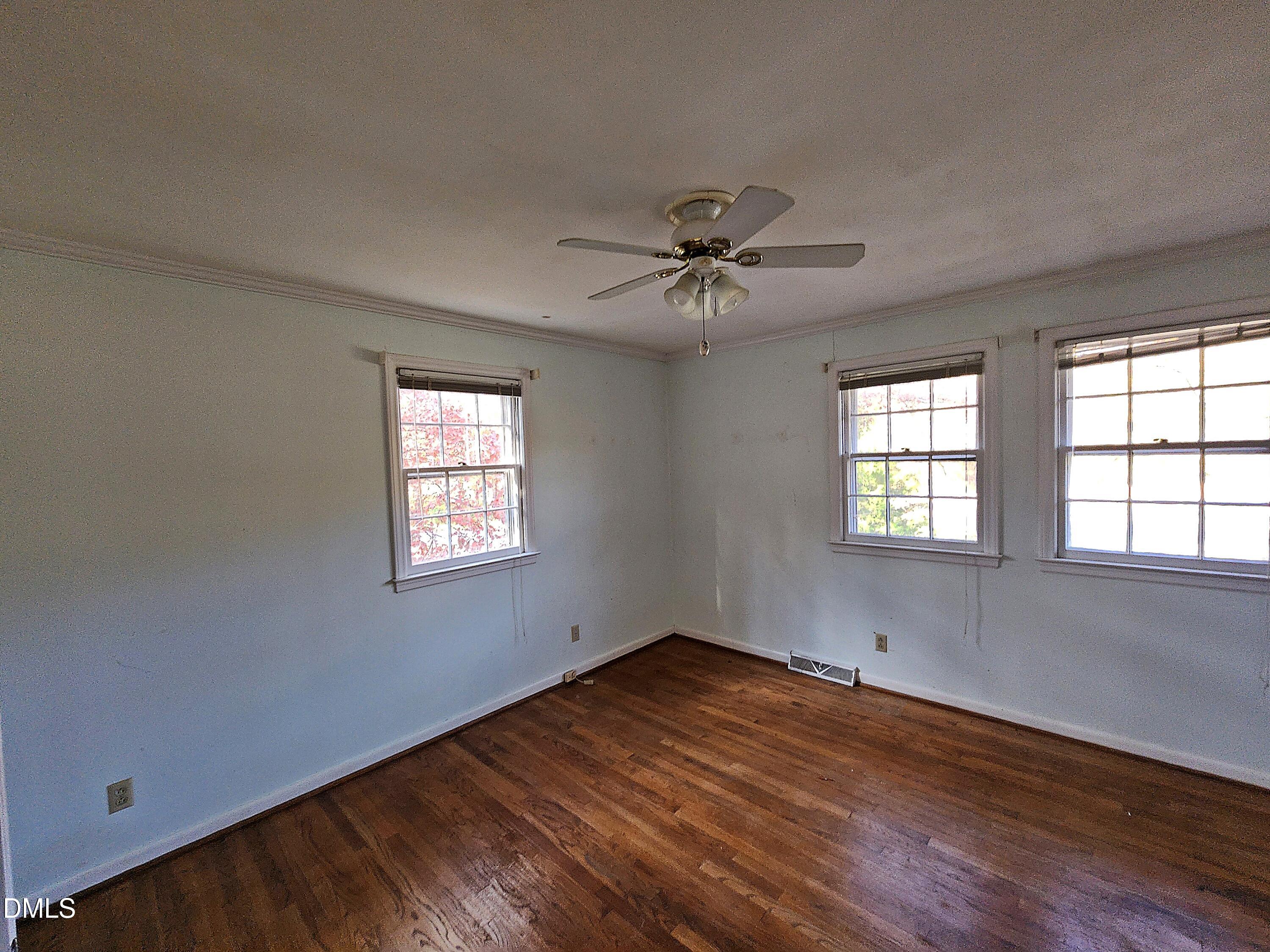 239 Hamilton Road Chapel Hill, NC 27517 - Photo 15 of 30 a view of an empty room with a window and wooden floor