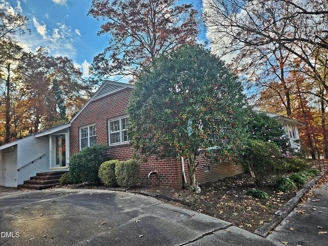 a bathroom with a granite countertop a sink a toilet and a shower