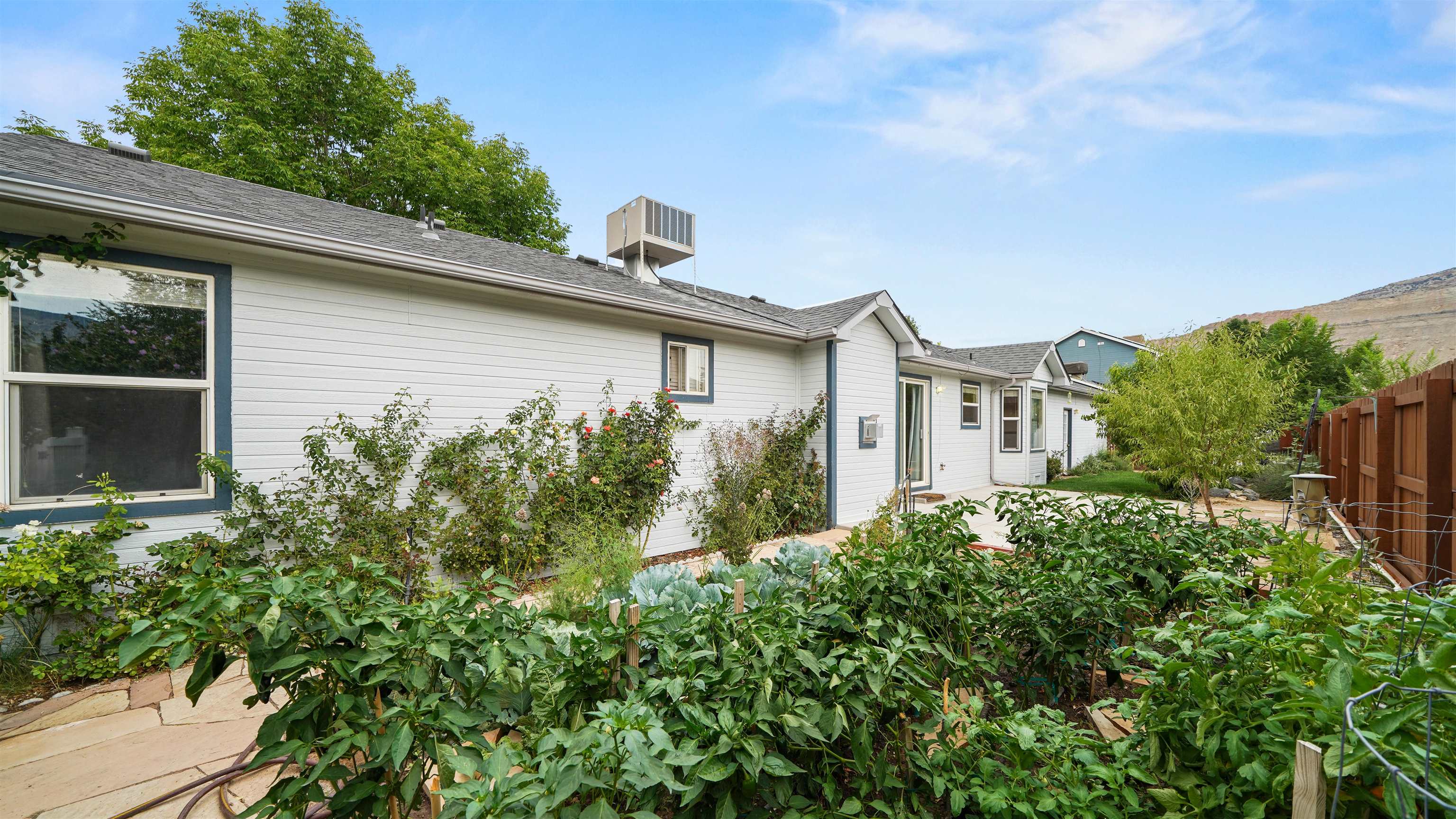 819 Elberta Avenue Palisade, CO 81526 - Photo 16 of 40 a view of a house with brick walls and plants