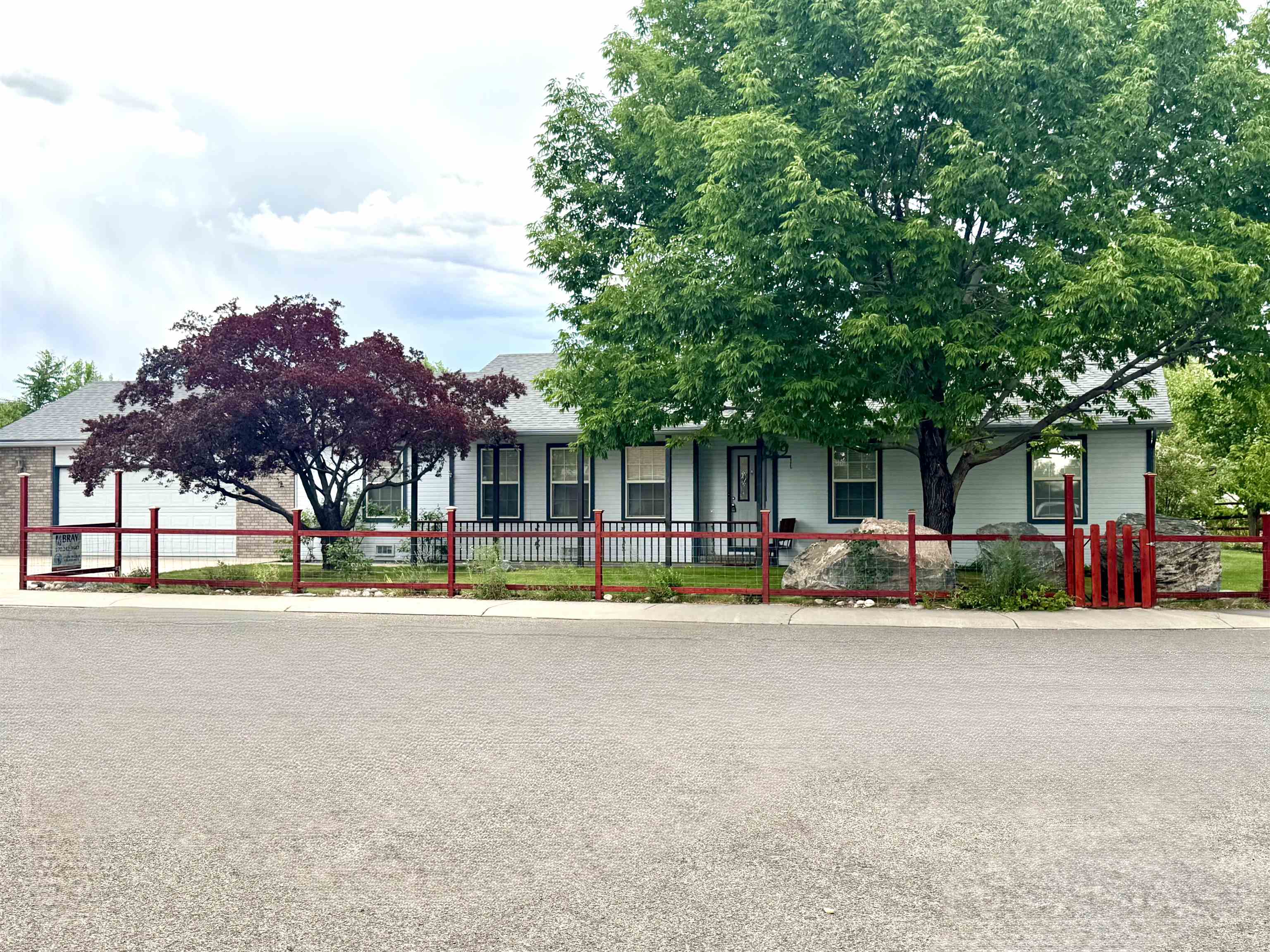 819 Elberta Avenue Palisade, CO 81526 - Photo 19 of 40 front view of a house with a patio yard and a large tree