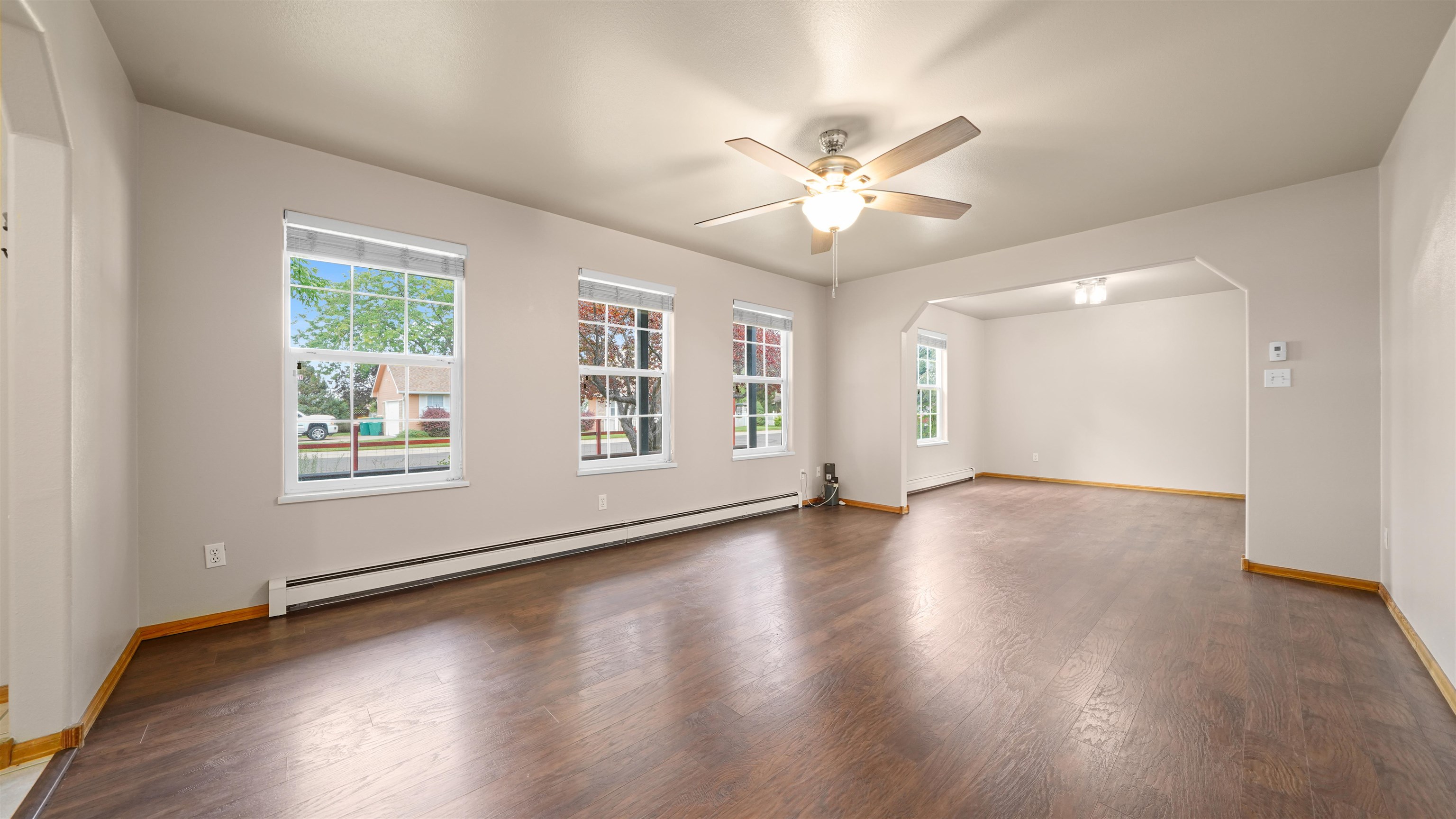 819 Elberta Avenue Palisade, CO 81526 - Photo 2 of 40 a view of an empty room with wooden floor and a window