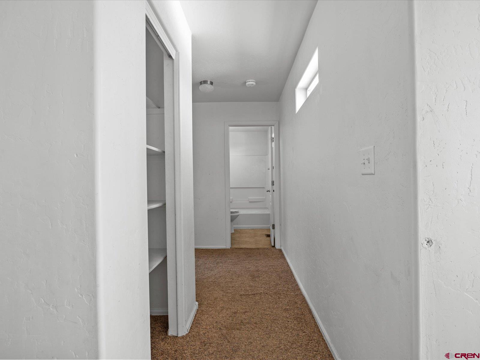 2473 Brookwillow Loop Grand Junction, CO 81505 - Photo 11 of 19 a view of a hallway with wooden shelves