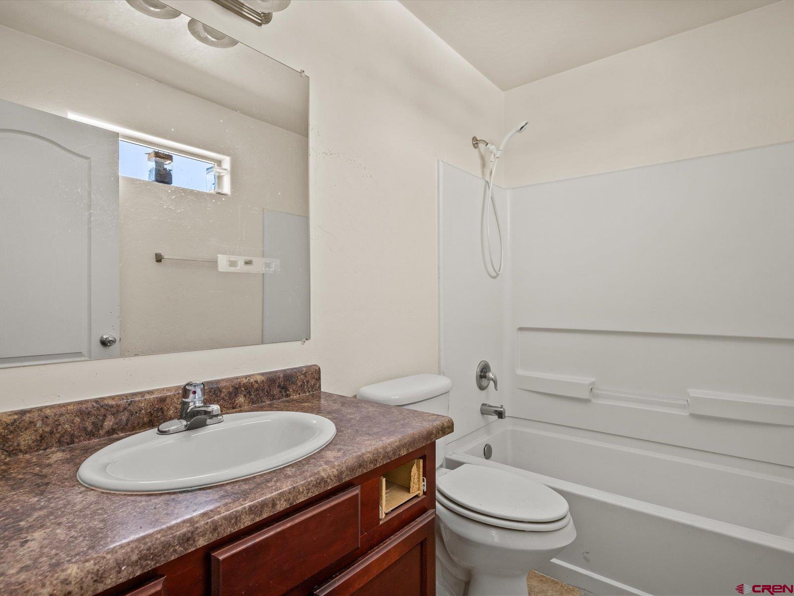 2473 Brookwillow Loop Grand Junction, CO 81505 - Photo 13 of 19 a bathroom with a granite countertop sink a toilet and a mirror