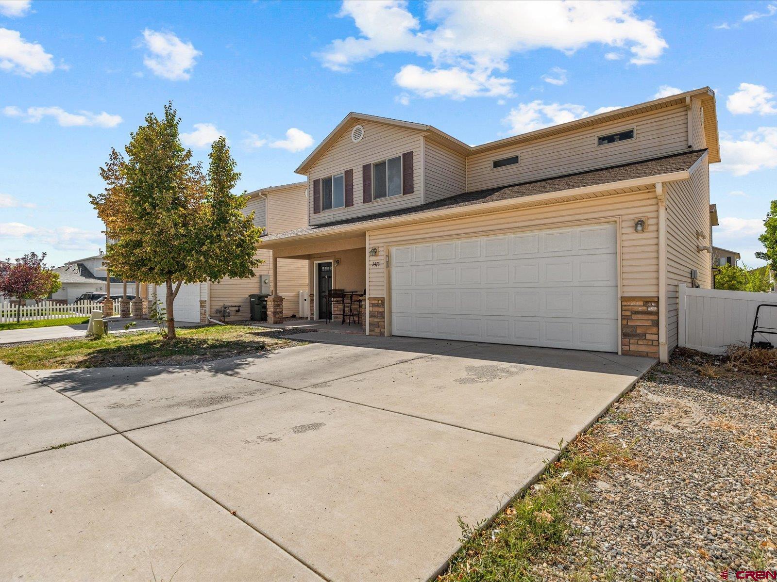 2473 Brookwillow Loop Grand Junction, CO 81505 - Photo 2 of 19 a view of garage with a car parked on the road