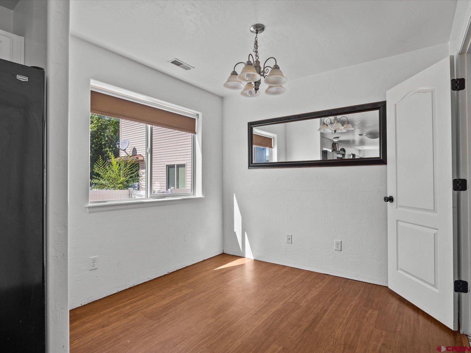 2473 Brookwillow Loop Grand Junction, CO 81505 - Photo 5 of 19 a view of an empty room with window and wooden floor