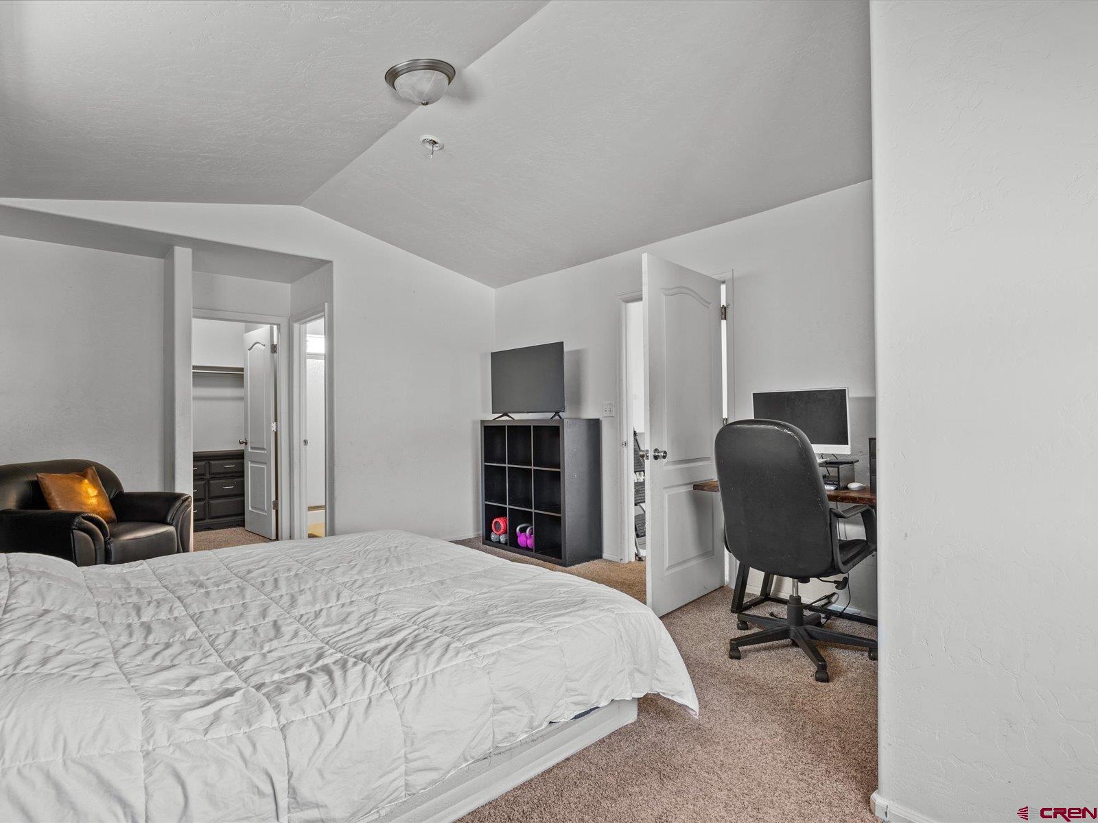 2473 Brookwillow Loop Grand Junction, CO 81505 - Photo 9 of 19 a bedroom with a bed a desk and chair