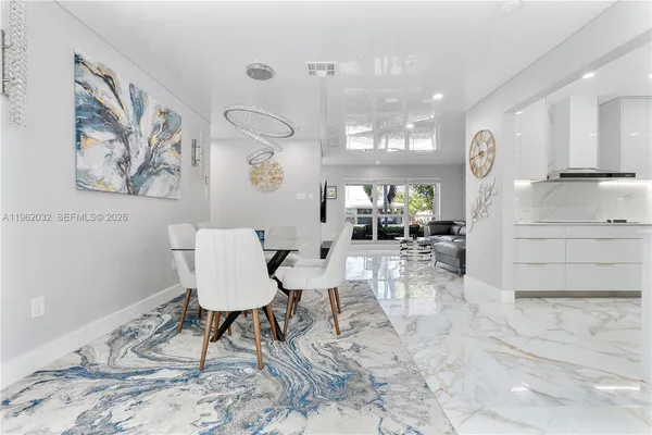 a spacious bedroom with a large bed and a chandelier