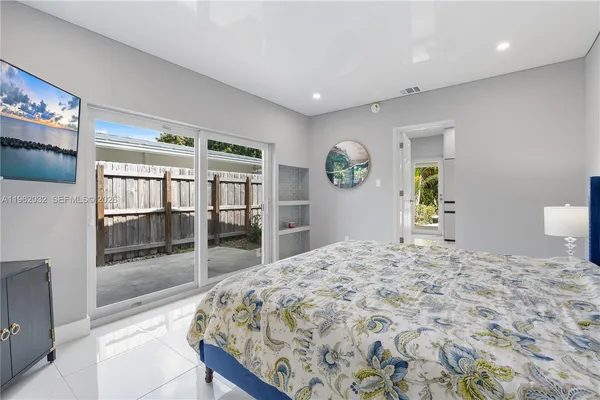 a bedroom with two beds and a window