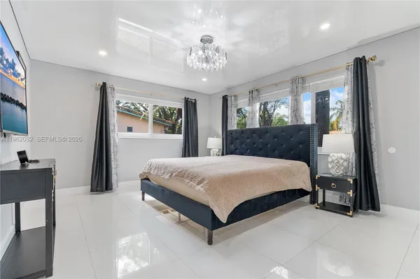 a bedroom with a large bed and a large window