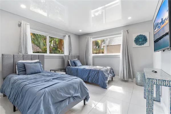 a view of a house with swimming pool and sitting area