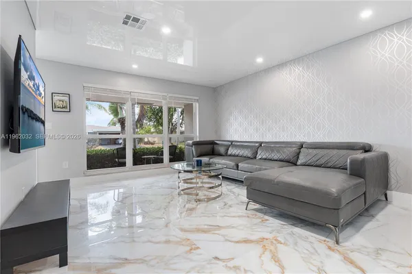 a living room with furniture and large window