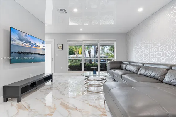 a view of a dining room with furniture a chandelier and wooden floor