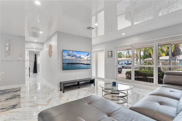 a view of a dining room with furniture a rug and wooden floor