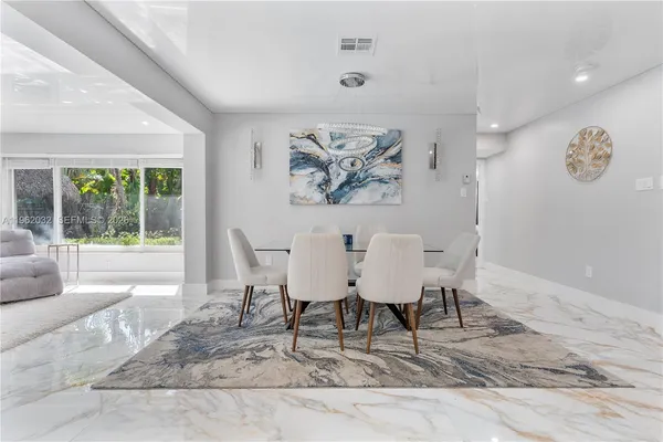 a kitchen with stainless steel appliances granite countertop a sink a refrigerator and a granite counter tops