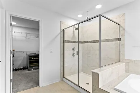 a bathroom with a shower and a glass door