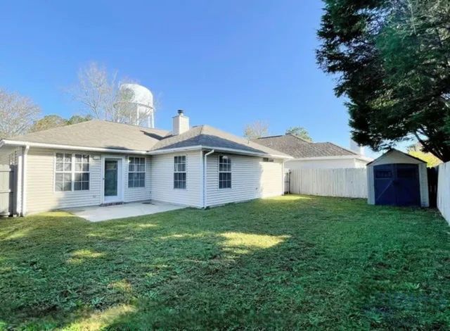 a view of a house with a yard and sitting area