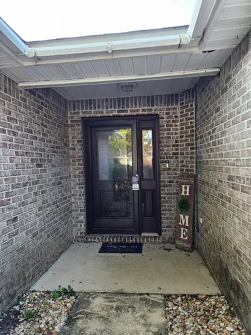 a view of a hallway with wooden floor and a fireplace