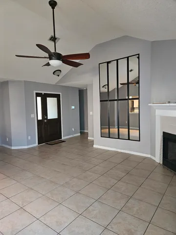 a view of an empty room with a fireplace