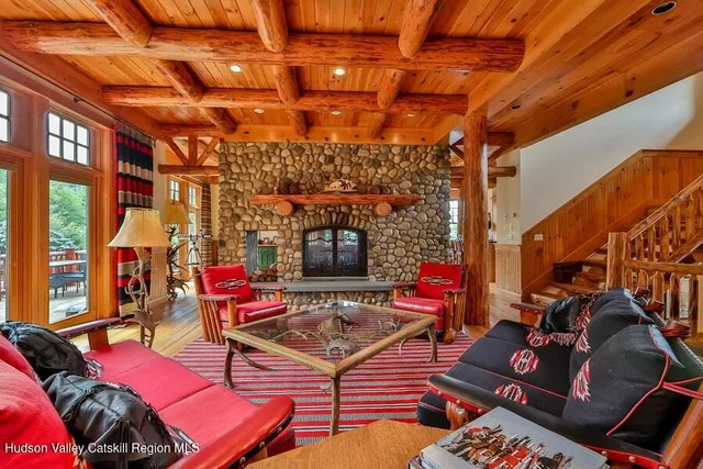 a view of a dining room with furniture large windows and wooden floor