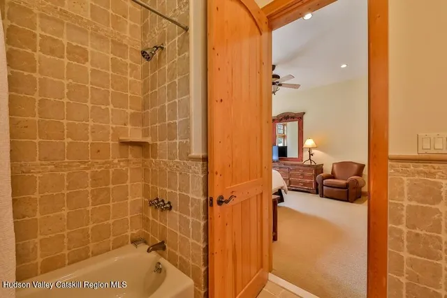 a bathroom with a toilet and a shower
