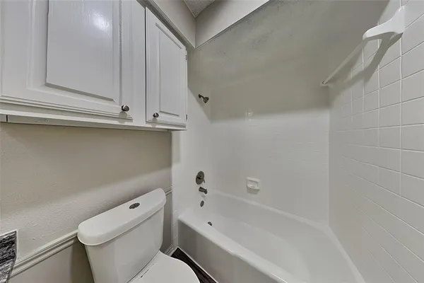 a bathroom with a toilet a sink and bathtub