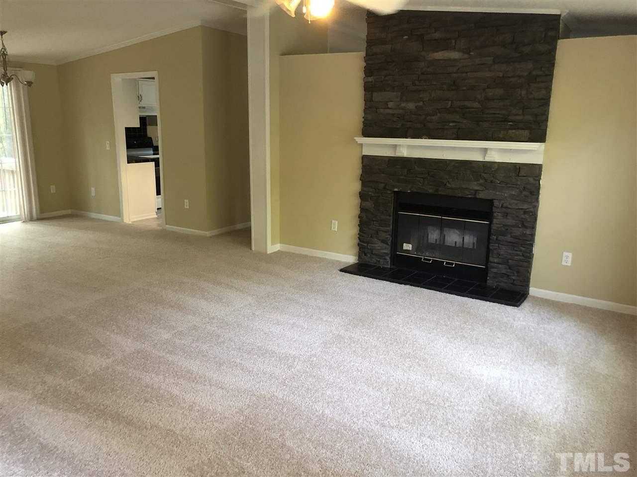1320 Yakimas Road Raleigh, NC 27603 - Photo 2 of 14 a view of an empty room with a fireplace