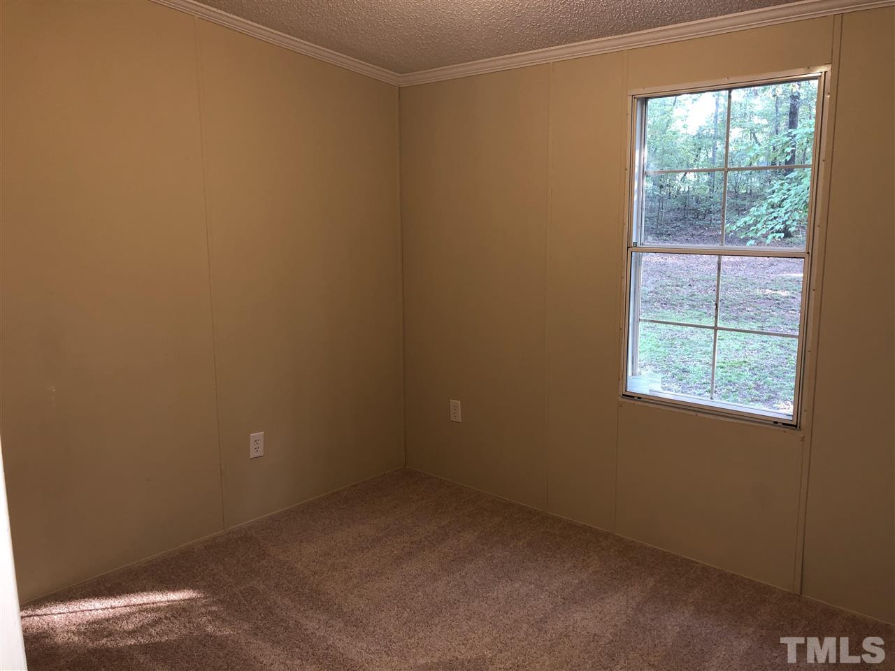 1320 Yakimas Road Raleigh, NC 27603 - Photo 11 of 14 an empty room with a window