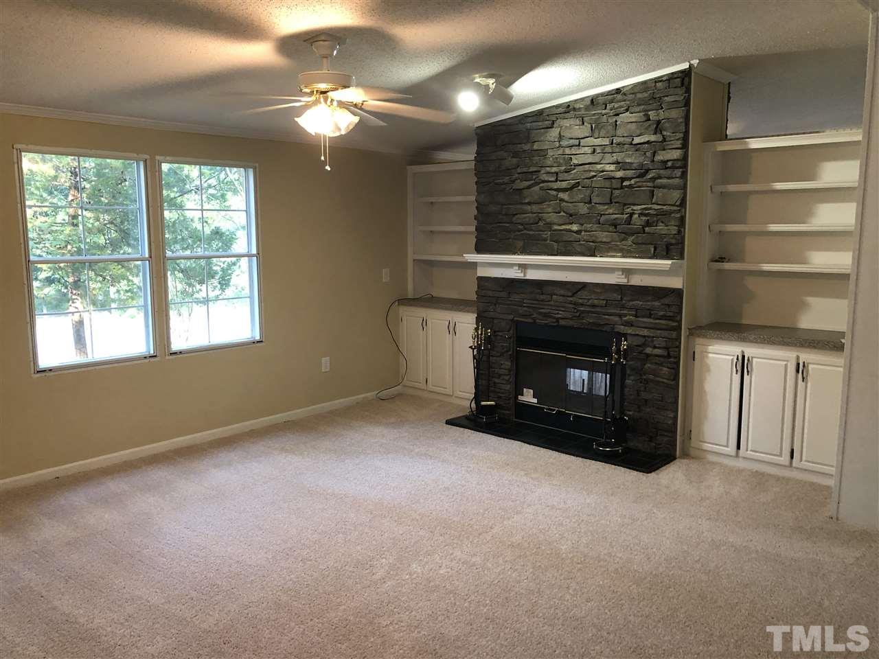 1320 Yakimas Road Raleigh, NC 27603 - Photo 4 of 14 a view of a livingroom with a fireplace and window