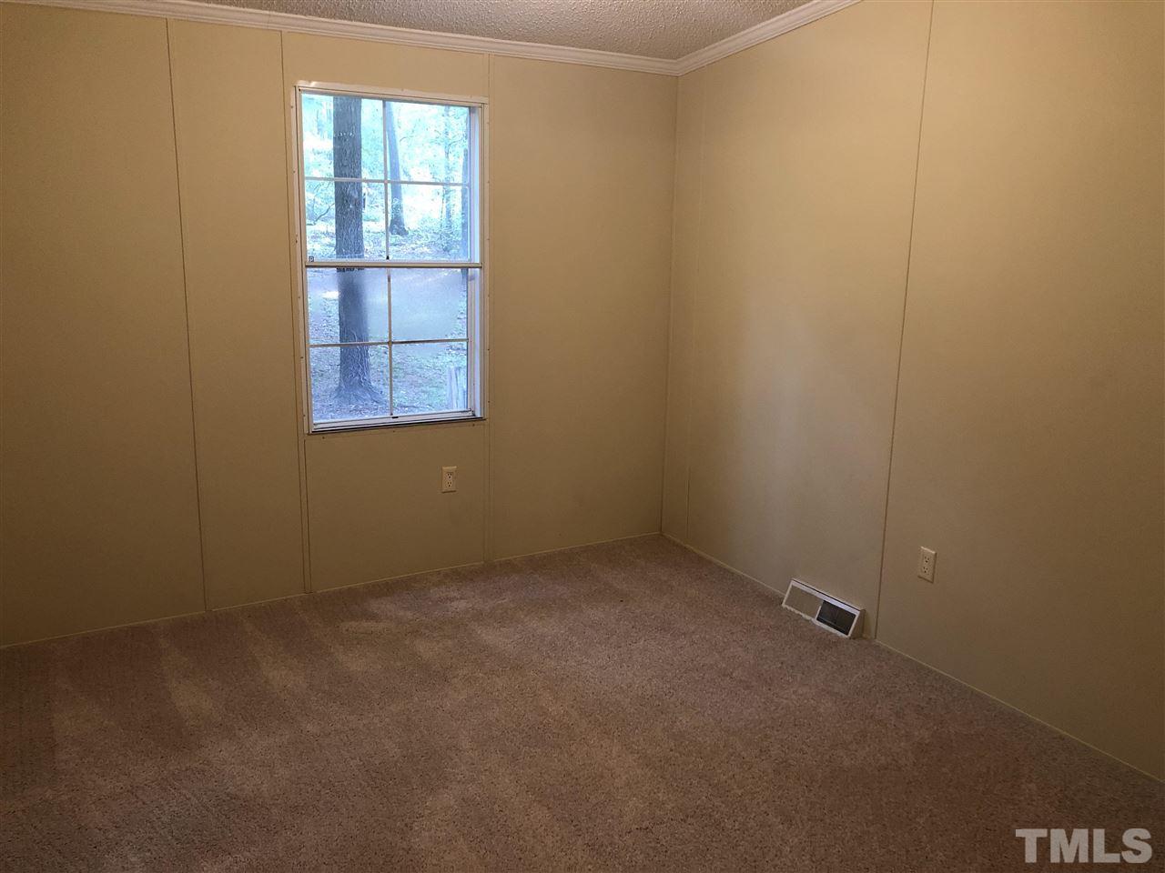 1320 Yakimas Road Raleigh, NC 27603 - Photo 6 of 14 an empty room with windows