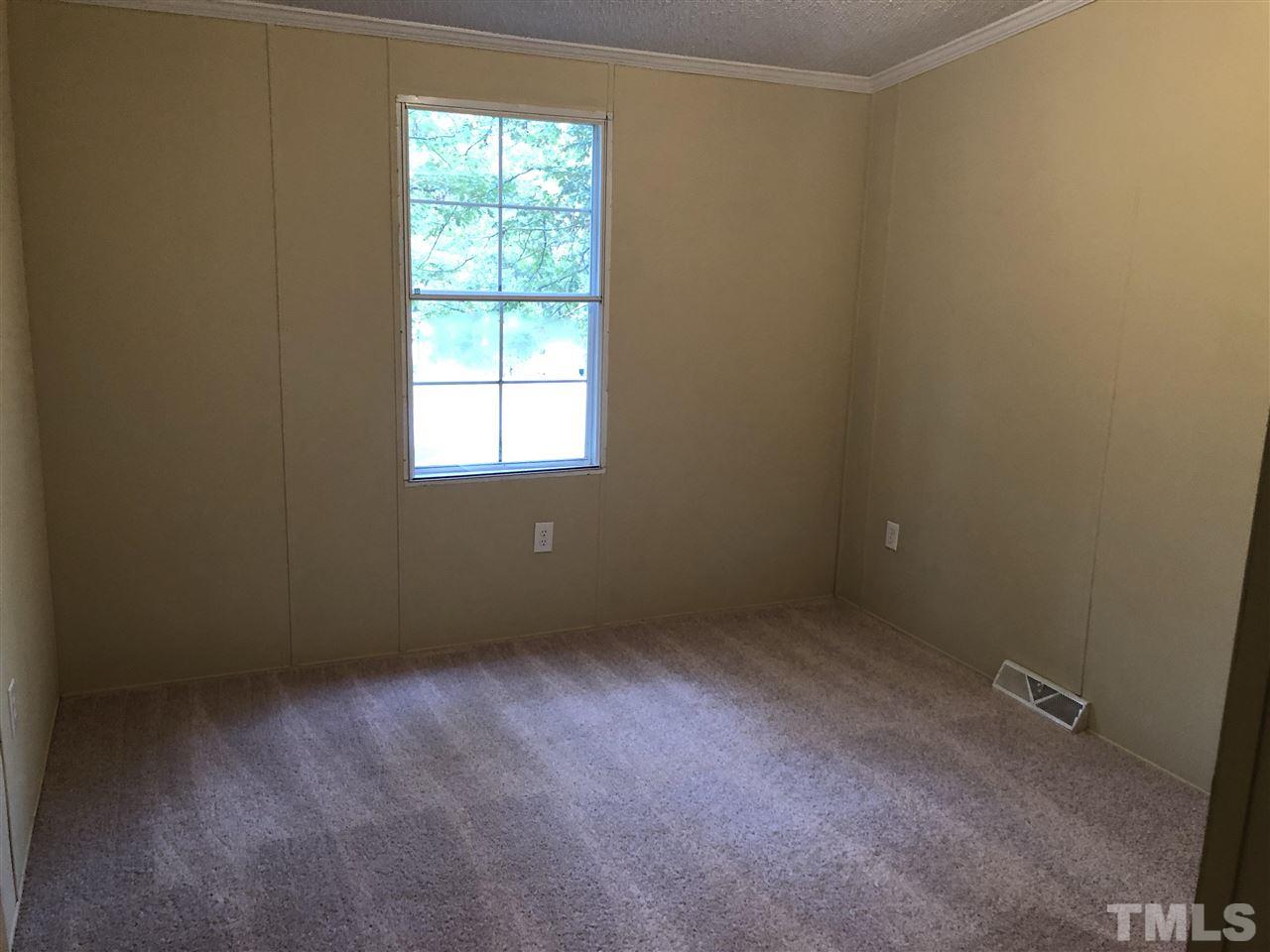 1320 Yakimas Road Raleigh, NC 27603 - Photo 9 of 14 an empty room with a window