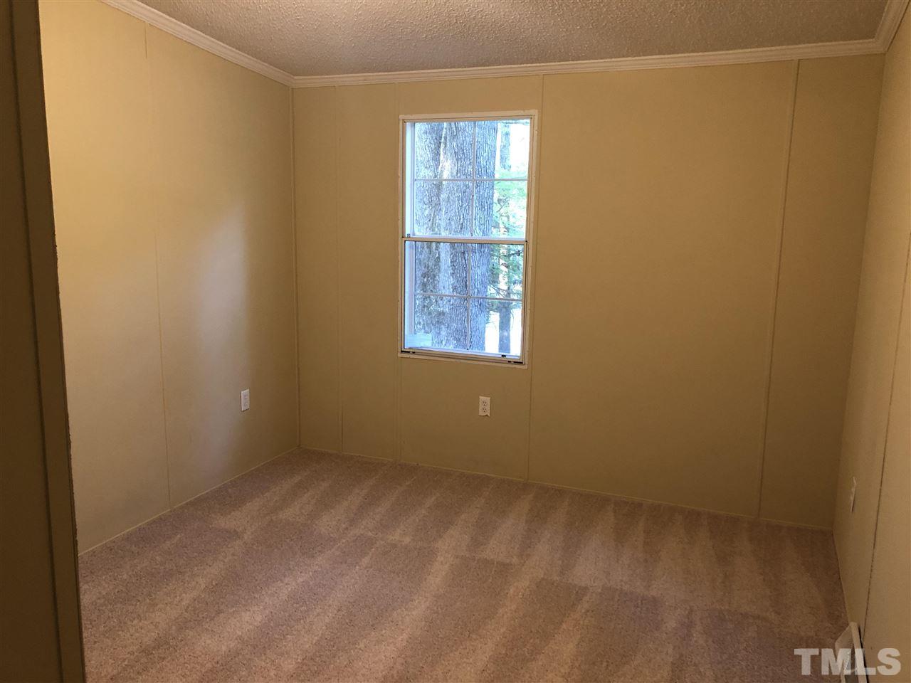 1320 Yakimas Road Raleigh, NC 27603 - Photo 10 of 14 a view of an empty room with a window