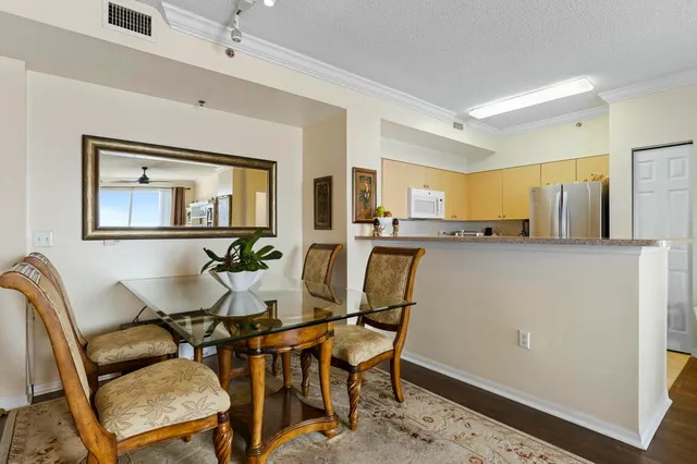 a view of a dining room with furniture and a window