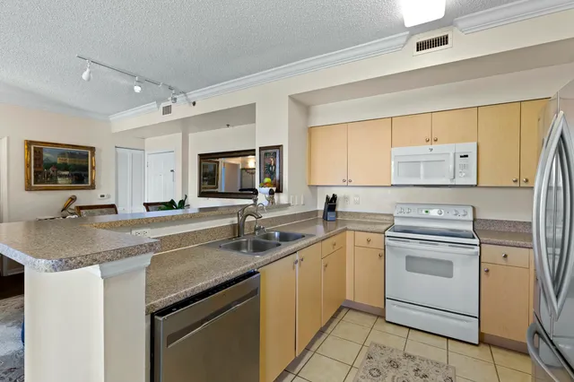a kitchen with a sink stove and microwave