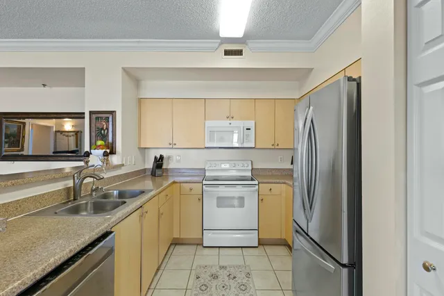 a kitchen with a sink stove and refrigerator