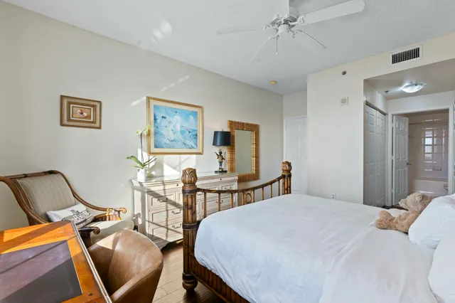 a bedroom with a bed a desk and chair