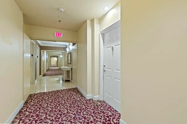 a hallway with a bedroom and bathroom