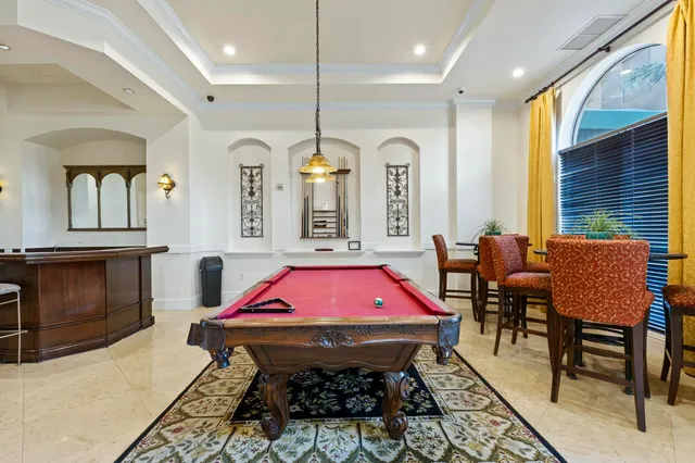a bath room with a table chairs and a kitchen view