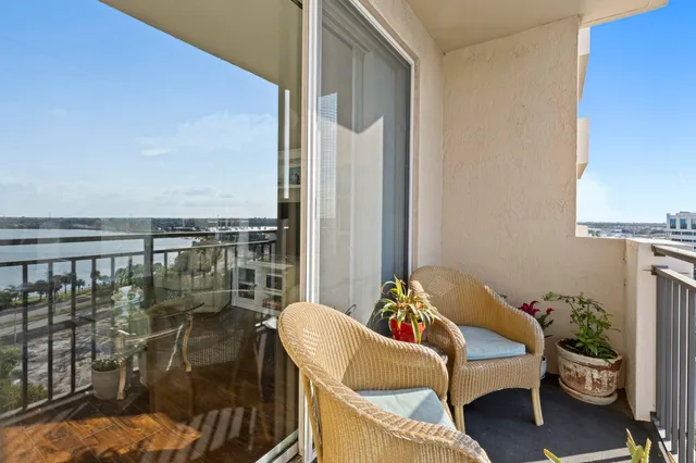 a balcony with furniture and a potted plant