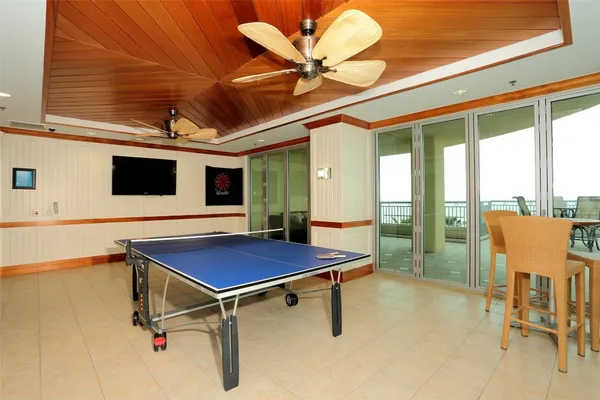 a room with pool table and glass windows