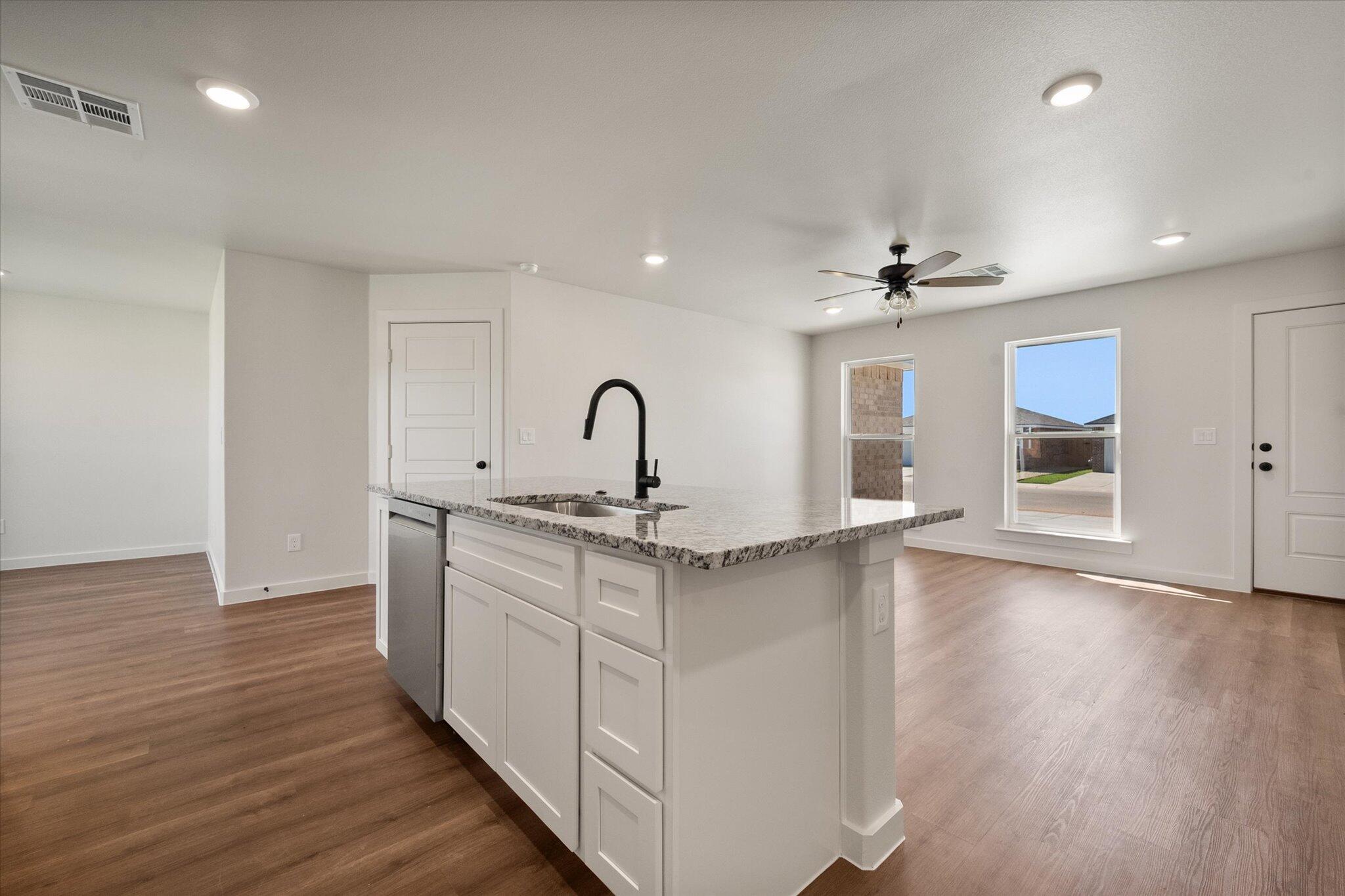 1320 North Colton Avenue Lubbock, TX 79416 - Photo 11 of 22 a kitchen with stainless steel appliances a sink cabinets and wooden floor