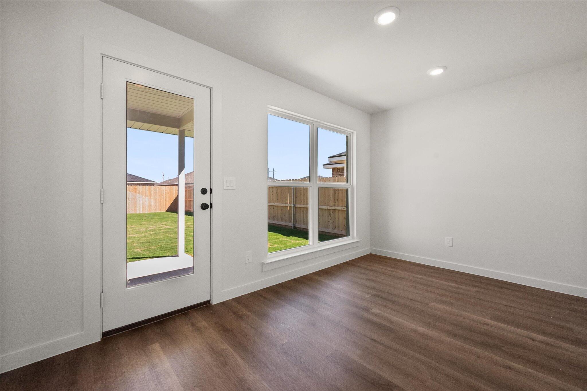 1320 North Colton Avenue Lubbock, TX 79416 - Photo 12 of 22 an empty room with wooden floor and windows
