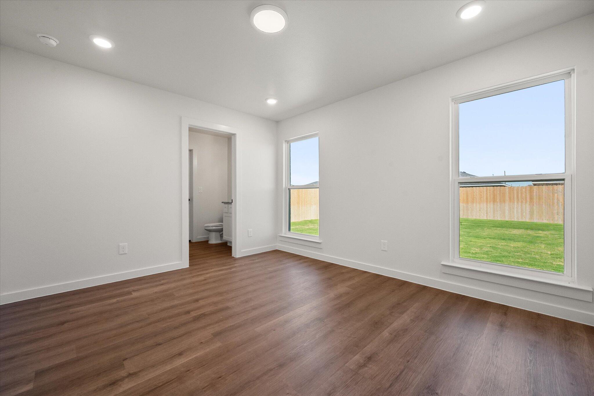 1320 North Colton Avenue Lubbock, TX 79416 - Photo 13 of 22 an empty room with wooden floor and windows