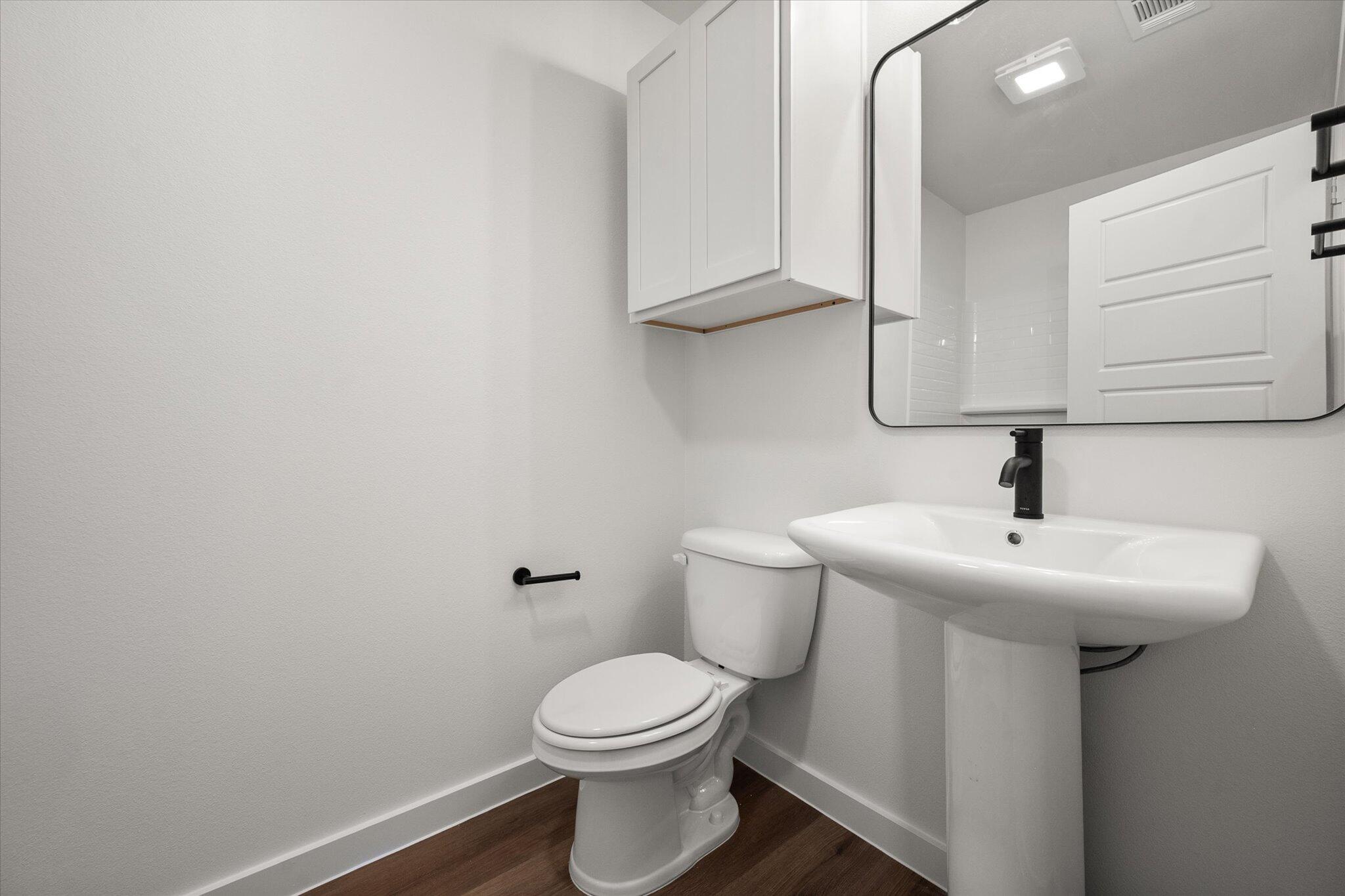 1320 North Colton Avenue Lubbock, TX 79416 - Photo 20 of 22 a bathroom with a sink a toilet and mirror