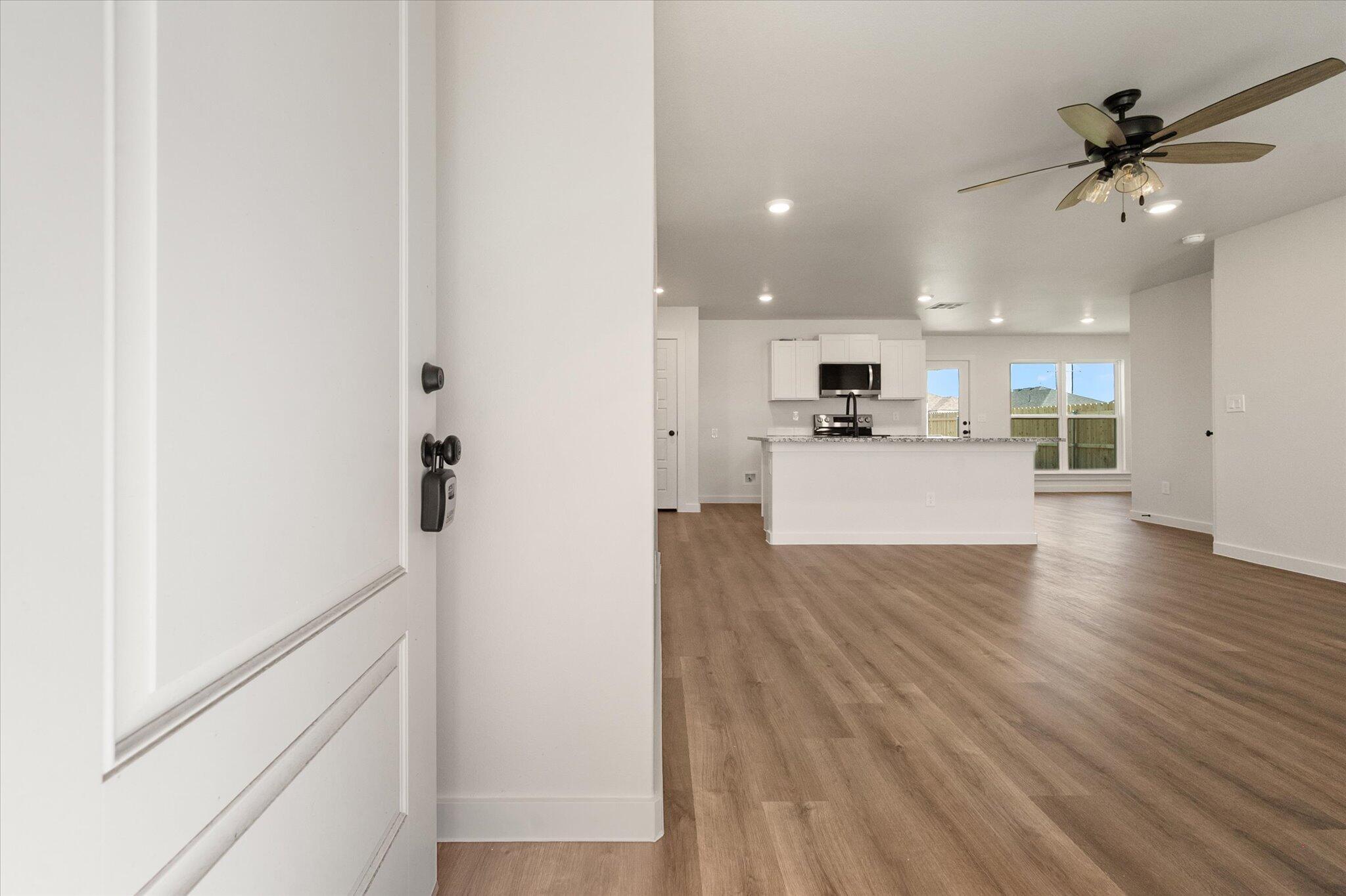 1320 North Colton Avenue Lubbock, TX 79416 - Photo 2 of 22 a view of a kitchen with wooden floor and a kitchen