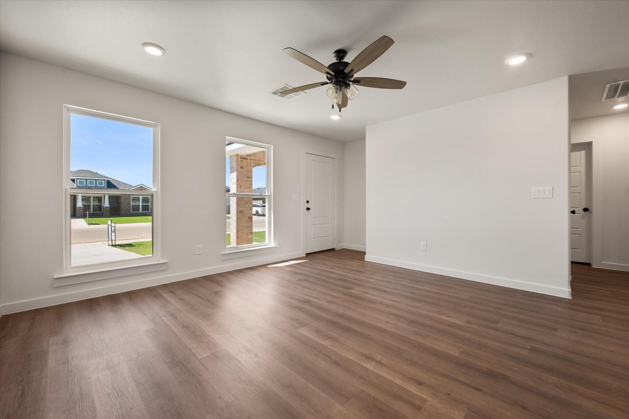 1320 North Colton Avenue Lubbock, TX 79416 - Photo 5 of 22 a view of empty room with wooden floor and fan