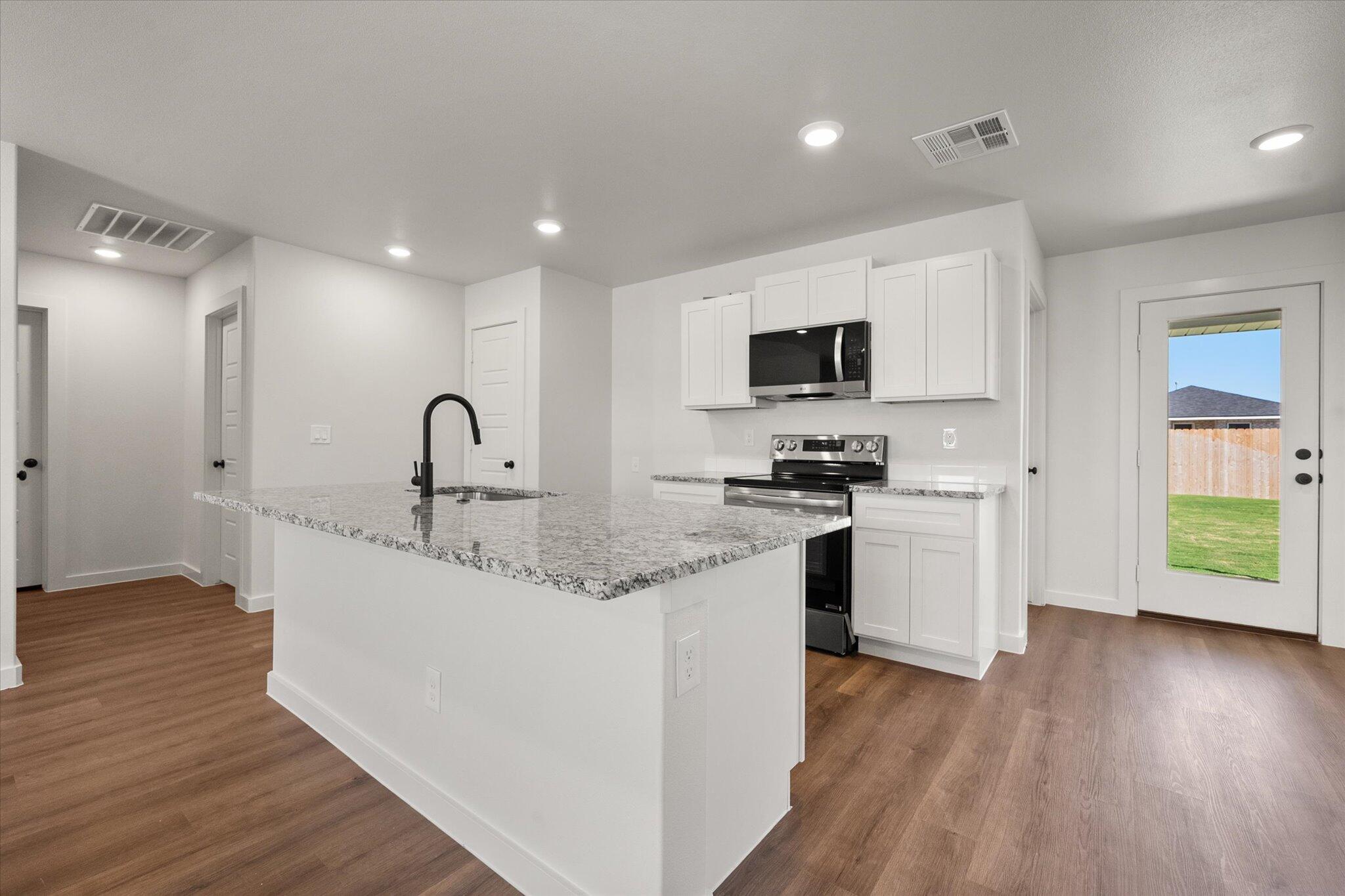 1320 North Colton Avenue Lubbock, TX 79416 - Photo 9 of 22 a kitchen with a sink stainless steel appliances and cabinets