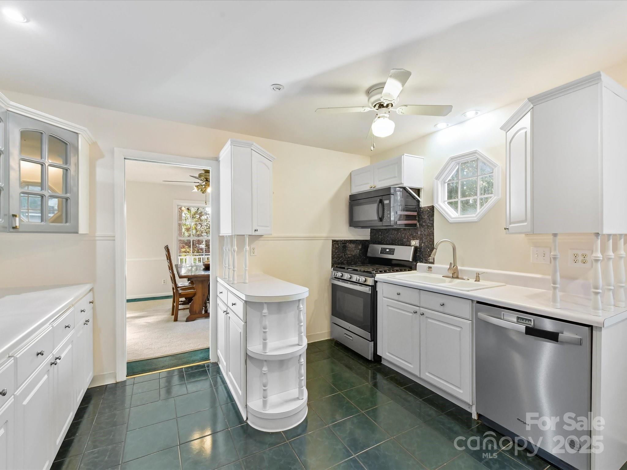 6313 Mill Grove Road Indian Trail, NC 28079 - Photo 18 of 47 a kitchen with a sink cabinets and appliances