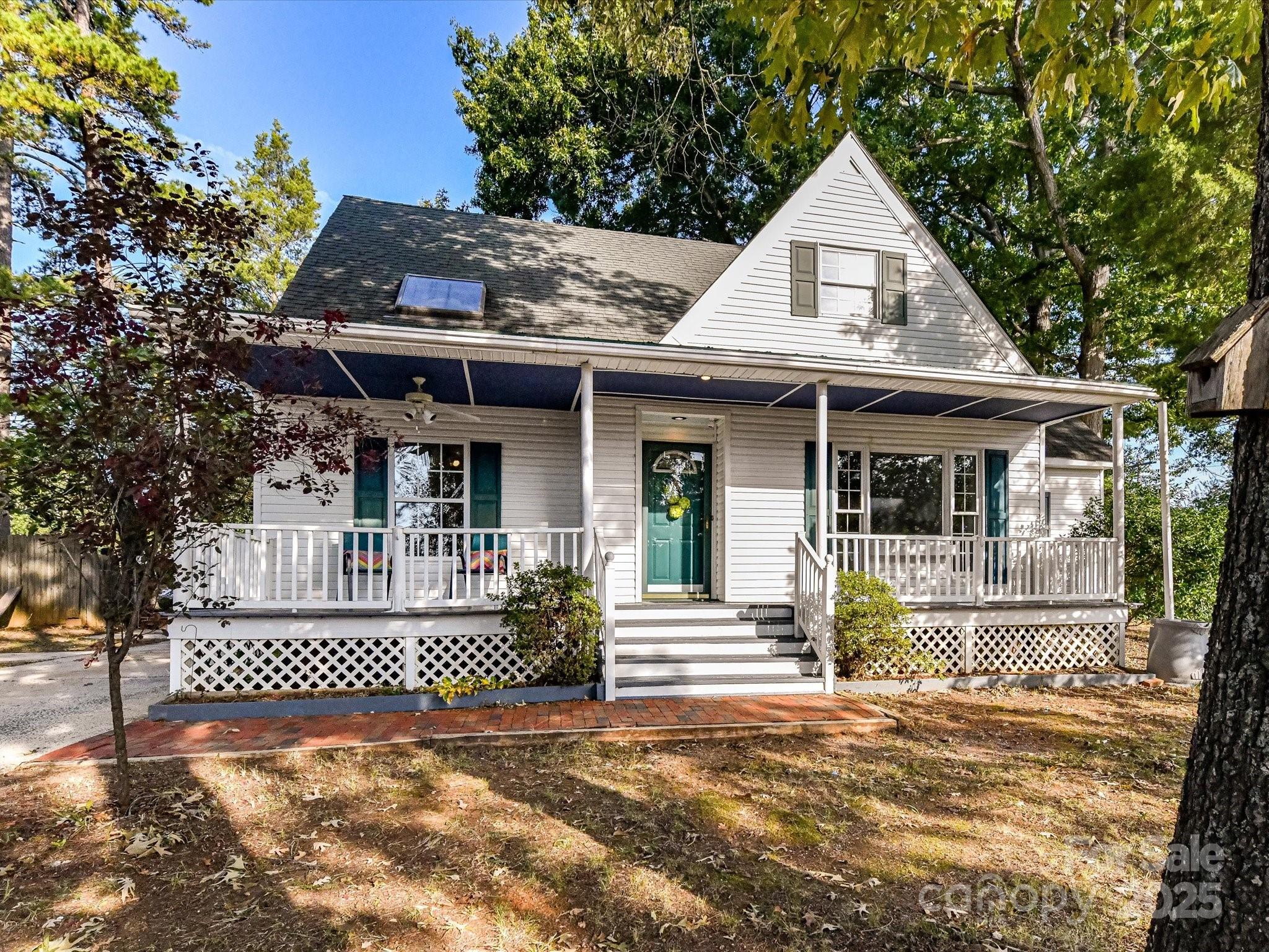 6313 Mill Grove Road Indian Trail, NC 28079 - Photo 2 of 47 a view of a house with a small yard plants and large tree